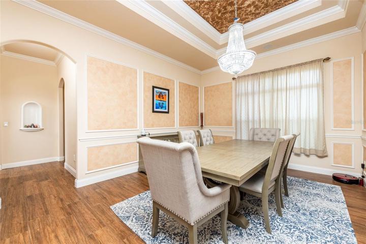 Formal Dining RoomCrown Molding Tray Ceiling, Chair Rail and Stunning Chandelier