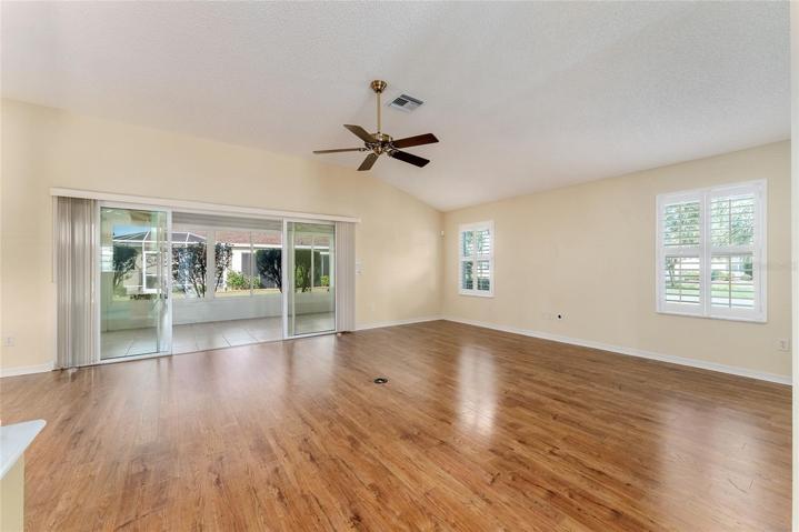 LIVING ROOM w/ SLIDING GLASS DOORS to ENCLOSED LANAI