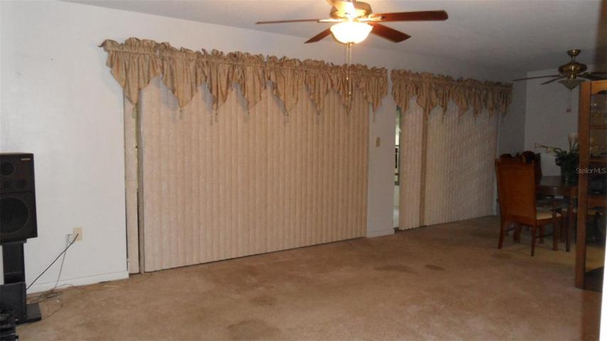 Combination Living room (with 8' sliding glass doors) and Dining room (with 6' sliding glass doors) and ceiling light/fans in each room