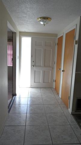 5' x 10' tiled foyer has 2 closets (one for coats and the other for vacuum cleaner)