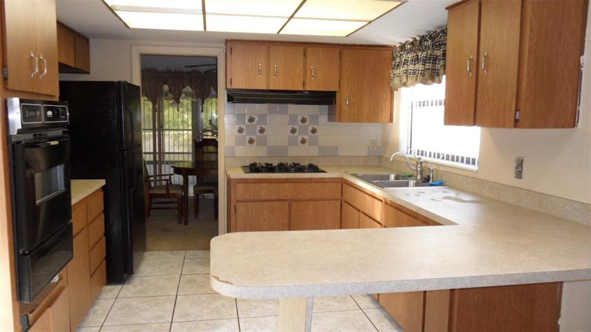 Large kitchen with gas stovetop and built-in oven, refrigerator and also included are the washer & dryer,