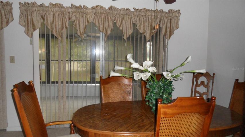 Dining room with ceiling fan/light and 6' sliding glass doors to patio