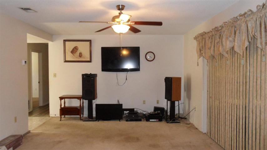 Living room has tv wall mounted and surround sound