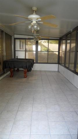 10'x 20' tiled patio has screen & vinyl windows, 2 ceiling fan/lights and an insulated ceiling.