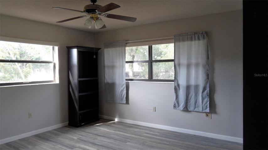 Large primary bedroom with ceiling fan/light, closets and en suite bathroom