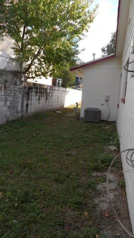 From rear of home this is the view of the left side yard and you do have a side service door to the garage.