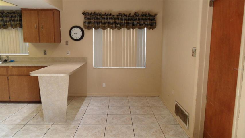 Kitchen with space for a table as well as the breakfast bar (door leads to garage - for ease in bringing in the groceries)