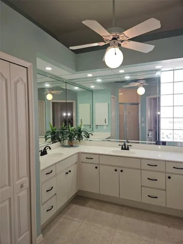 The master bathroom has added storage with an in-bath linen closet.