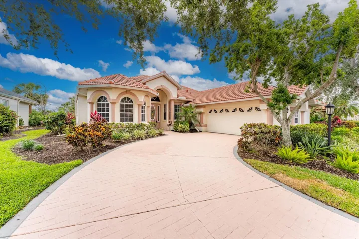 The lovely landscaping welcomes you in to your new Florida home!