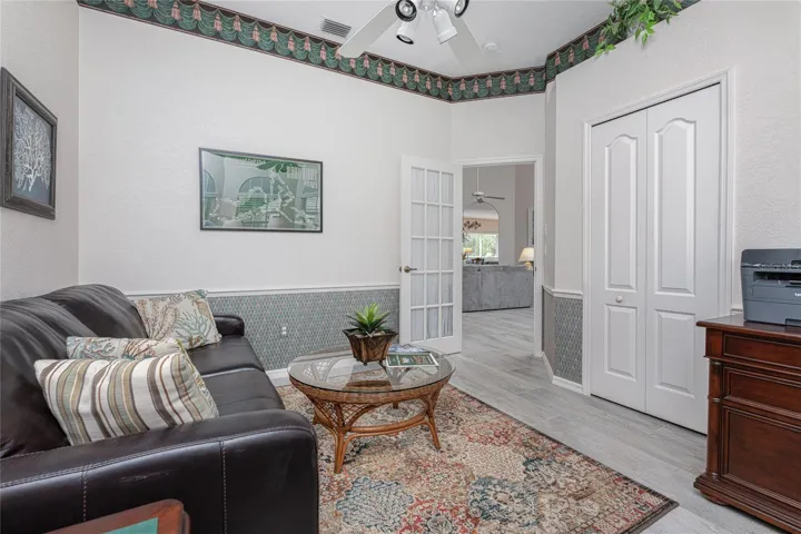 Guest bedroom #3/den features chair rail and a wall closet.
