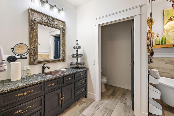 Custom vanities, copper sinks, and private water closet.