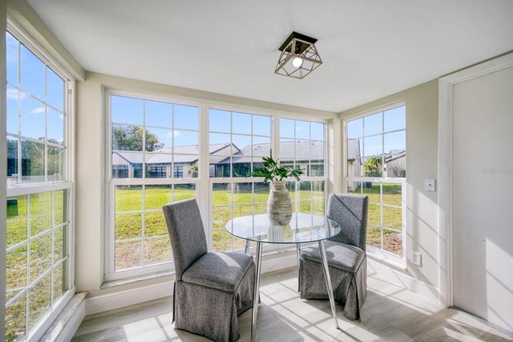 Updated hurricane rated windows surround the kitchen dining nook. Garage access door at right~