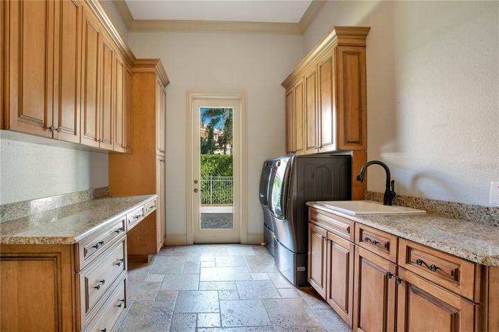 Downstairs laundry room with storage