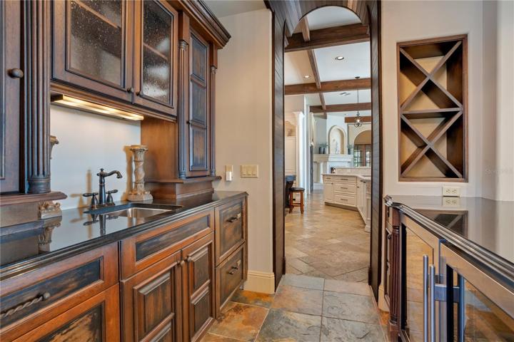Bar with subzero wine refrigerator, double dishwasher, ice maker, and wine rack