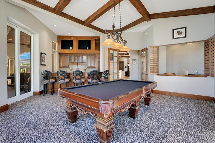 Game Room with full barand built ins for 3 TVs