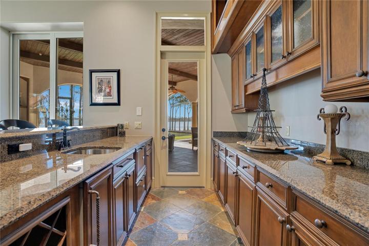 Full Bar with Subzero Refrigerator, access to lanai, ice maker and dishwashers