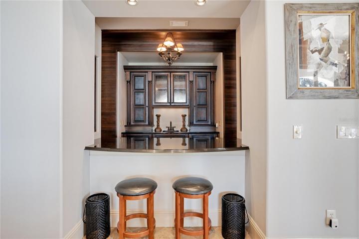 Bar with subzero wine refrigerator, double dishwasher, ice maker, and wine rack.