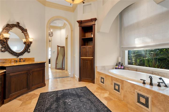 Primary Bathroom with built in laundry basket and tv center
