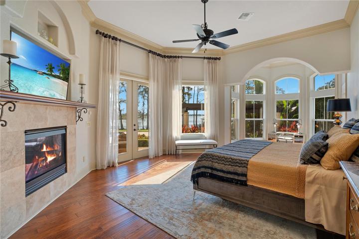 Primary Bedroom with natural gas fireplace and electric shades