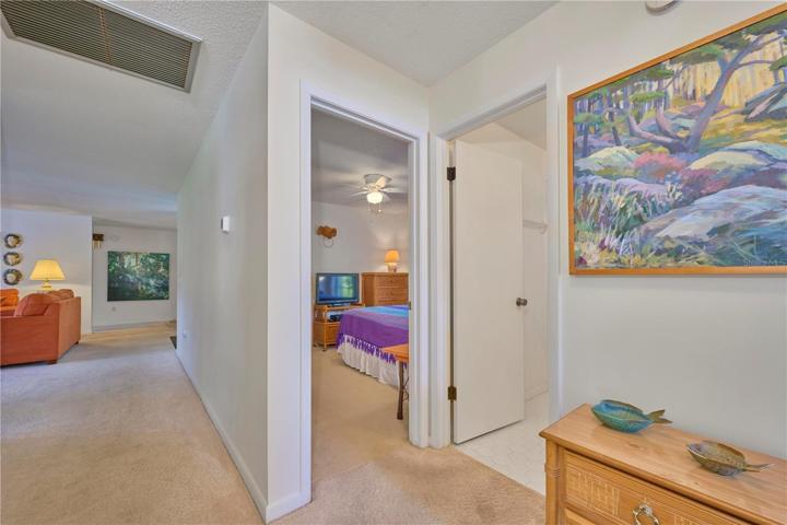 View looking back into living room and entrance to bedroom 2 and guest bathroom.