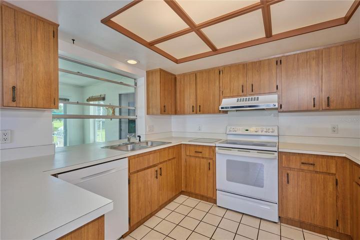 Kitchen has serving window out to the Florida room and lots of cabinet and counter space!  Refrigerator was replaced in 2022.