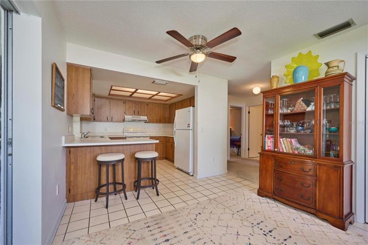 View of kitchen and dining room with look back into hallway.