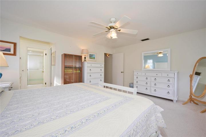 Master bedroom with view of entrance and ensuite bathroom