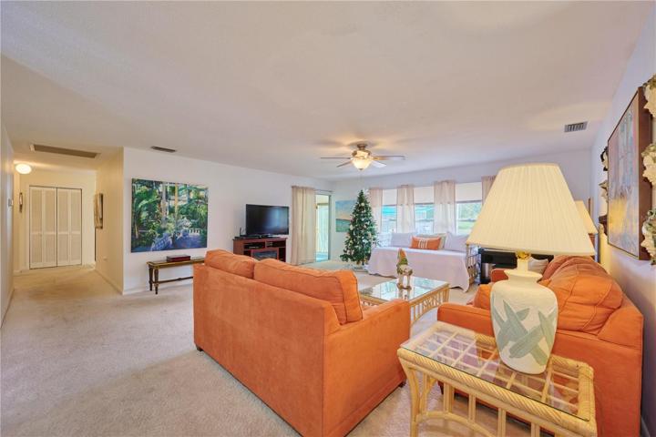 Living room with view of hallway.  The doorway in the rear of the picture goes out to the Florida room.