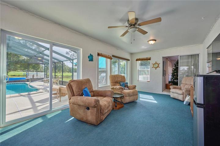 Florida room has double sliders that lead outside and to the pool area.  The sliders to the right access the living room.