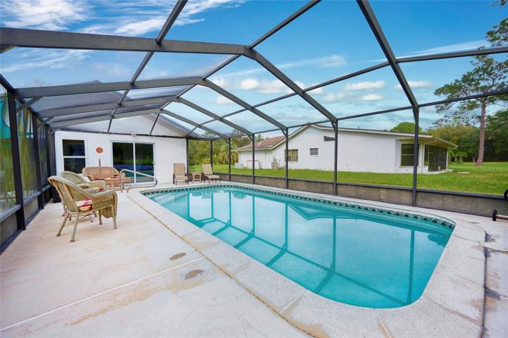 Reverse view of pool looking back to sliders that access the Florida room.