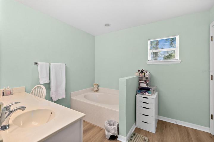en suite bathroom with garden tub, separate shower