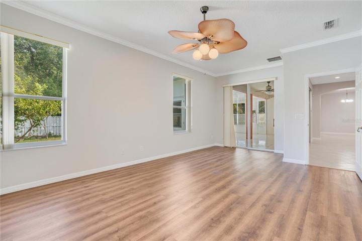 The large primary bedroom on the first floor has views of the Florida room and the backyard.