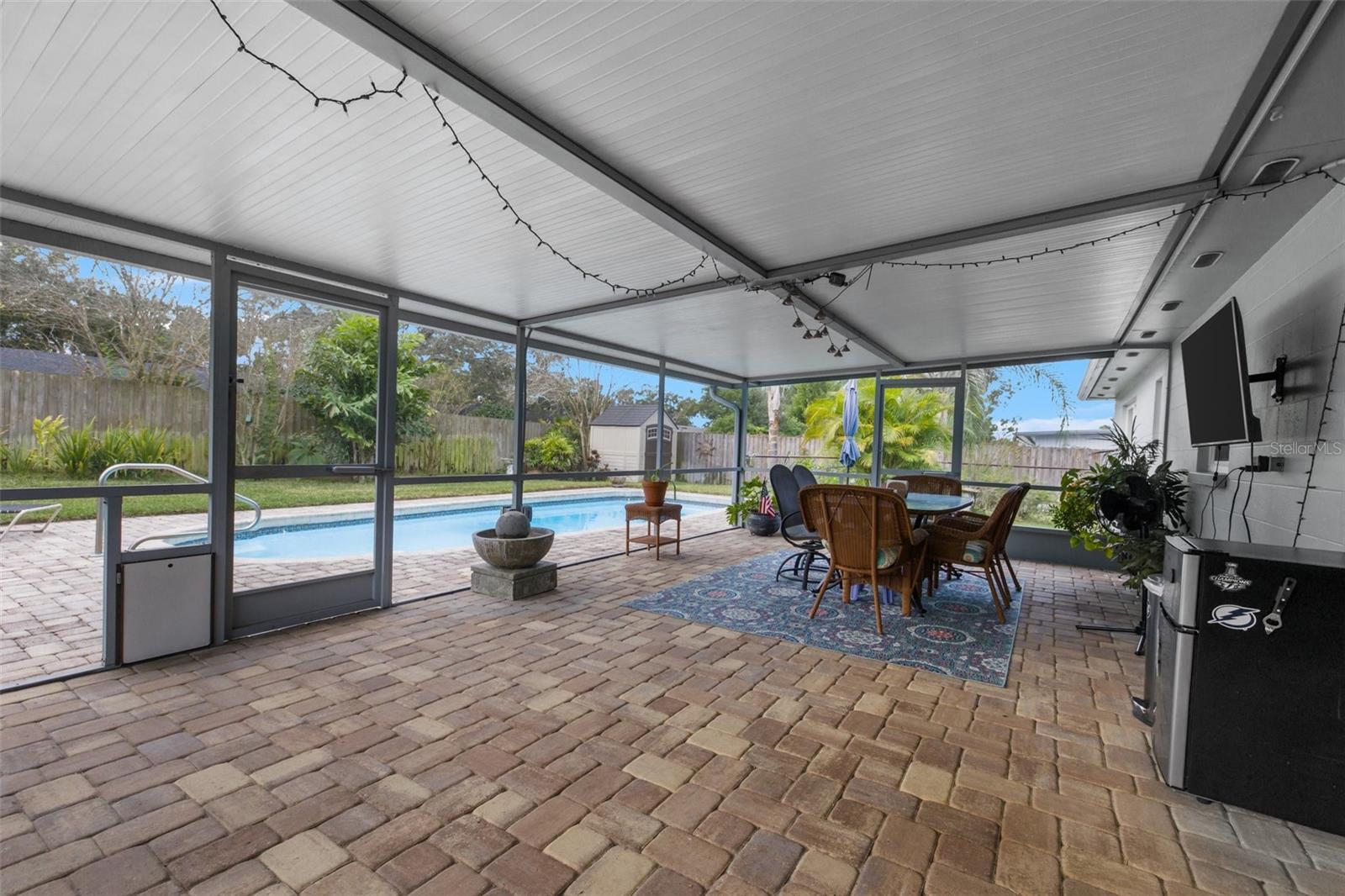 Large Patio with pavers and door to fenced in turf area for play or pups