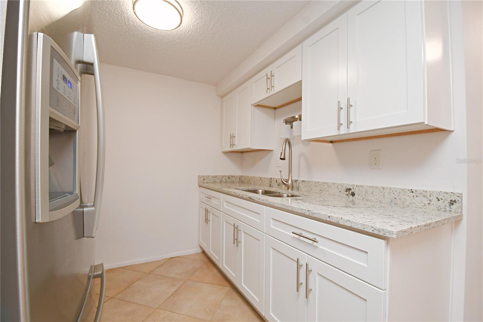 The kitchen has been completely renovated and showcases sleek stainless steel appliances, new cabinets, garbage disposal, and gorgeous granite countertops.