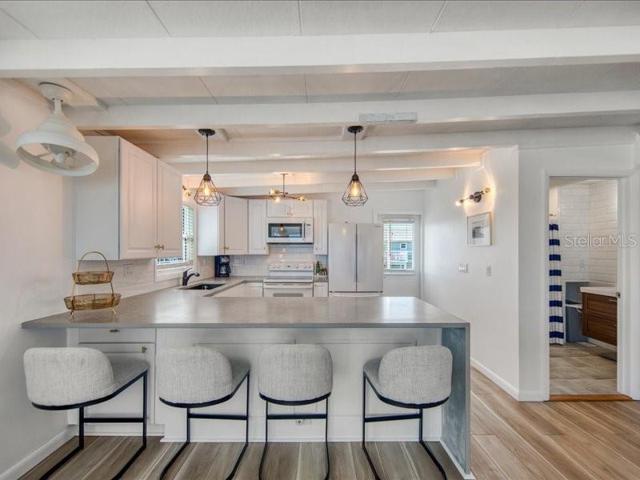 Kitchen offers bar seating updated appliances, cabinets, and stone countertops!