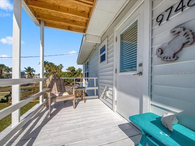 Back entrance of the home enters through the kitchen and has a covered porch!