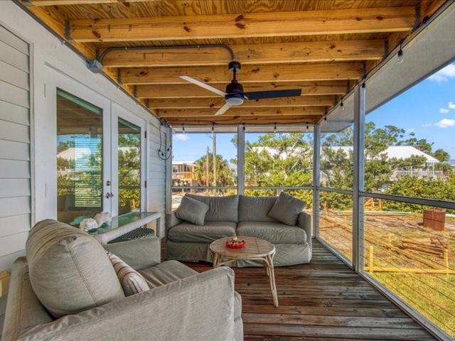 The screened front porch is a great place to relax!