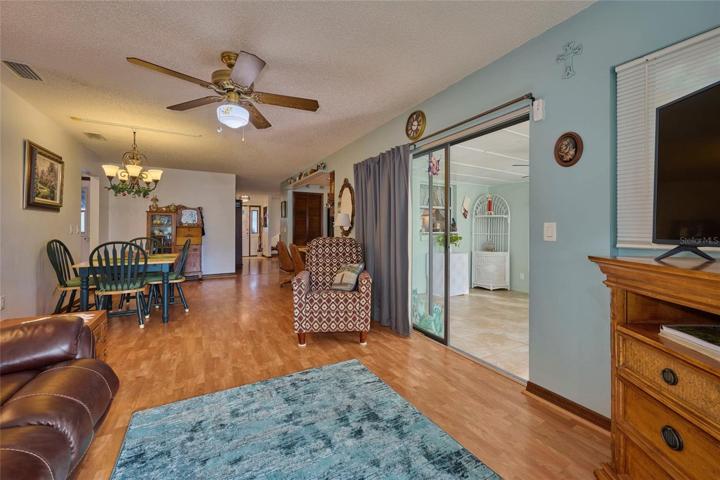 Reverse view of family room looking back into dining area and living room.  Florida room to the right out the sliders.