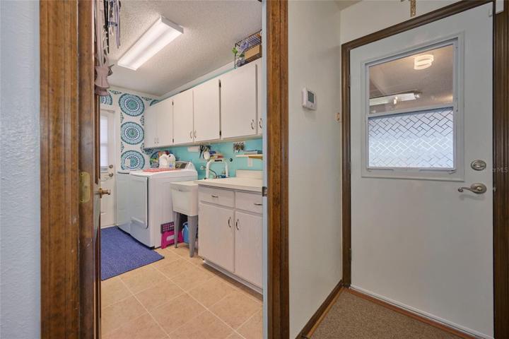 Laundry room with view of garage access door