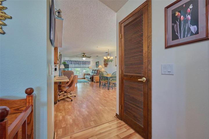 View into family/dining room.  Door to the right is a storage closet