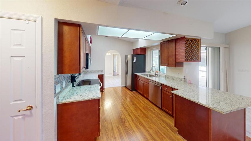 Upgraded kitchen with granite conters, wood cabinets, laminate flooring, stainless steel appliances