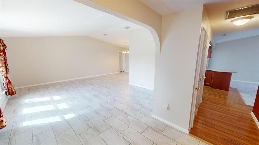 Front foyer leading into living room with upgraded ceramic tile.