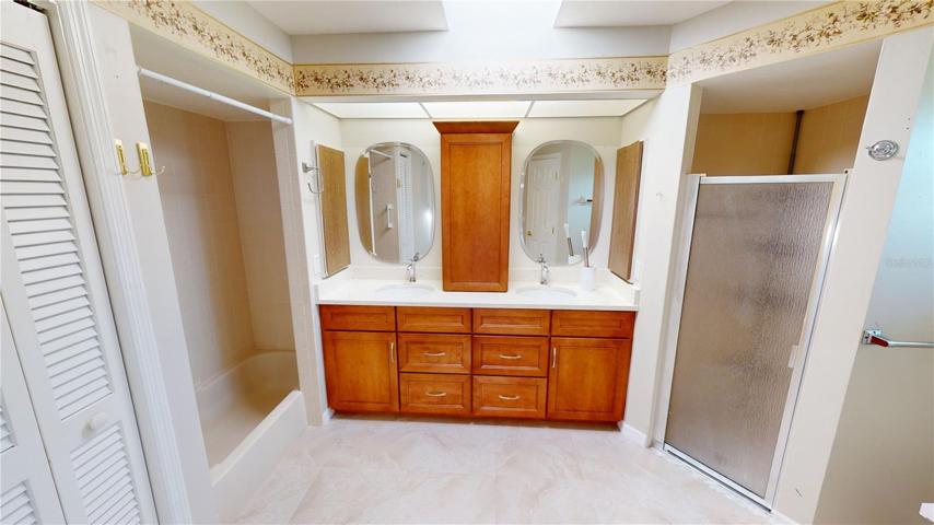 Upgraded Primary bathroom with dual vanities and new ceramic flooring