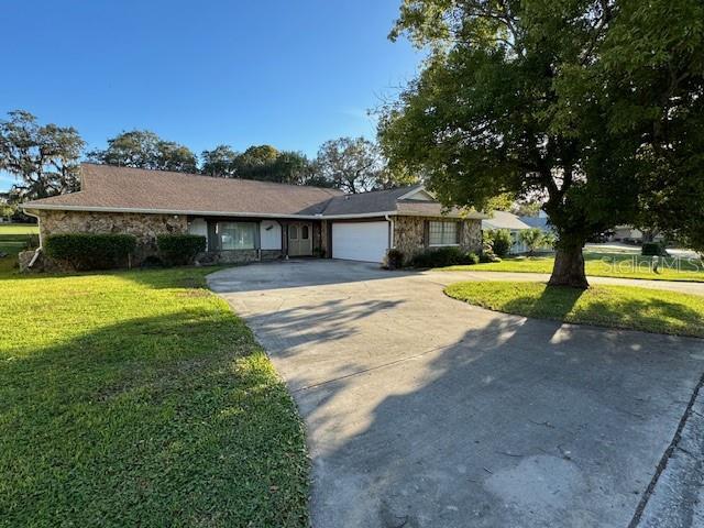 Front exterior with 2 car garage and circular driveway