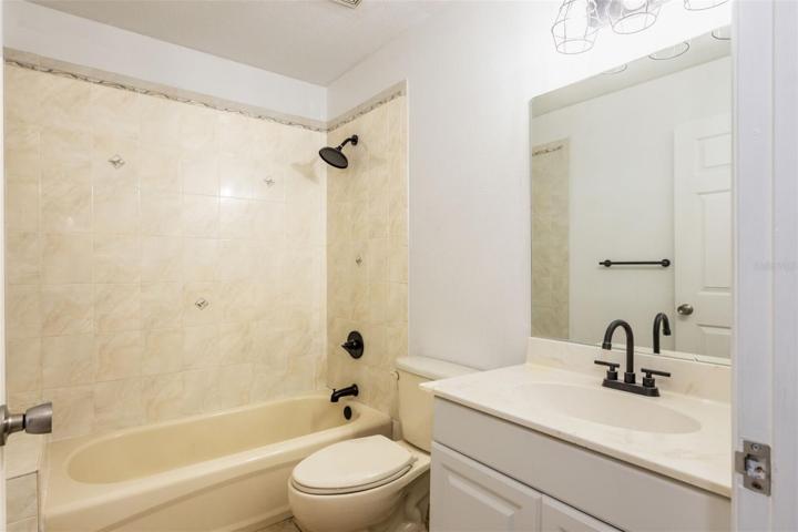 Fabulous guest bath with new vanity on porcelain tile countertop