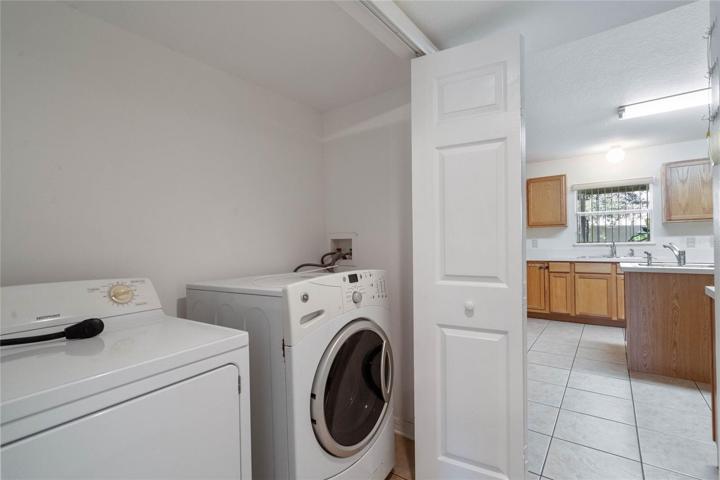Laundry closet located off kitchen area.