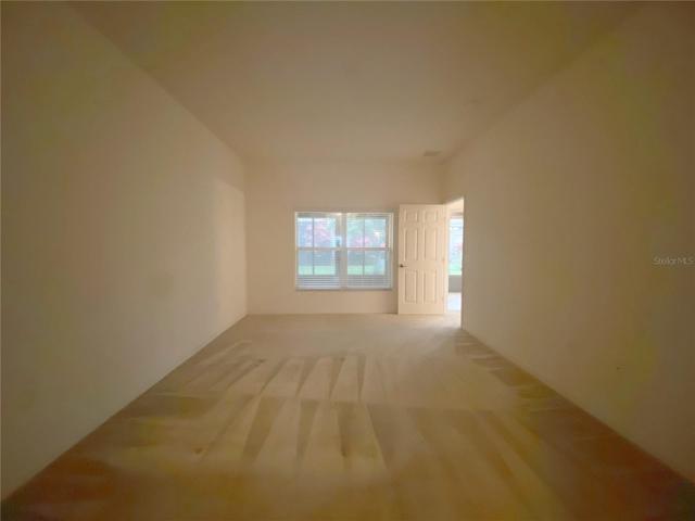 Master Bedroom with window overlooking enclosed lanai with tile floor