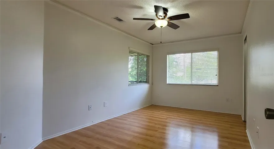 Bedroom 2 with en-suite bathroom, BIG walk-in closet and pretty view of your screened porch