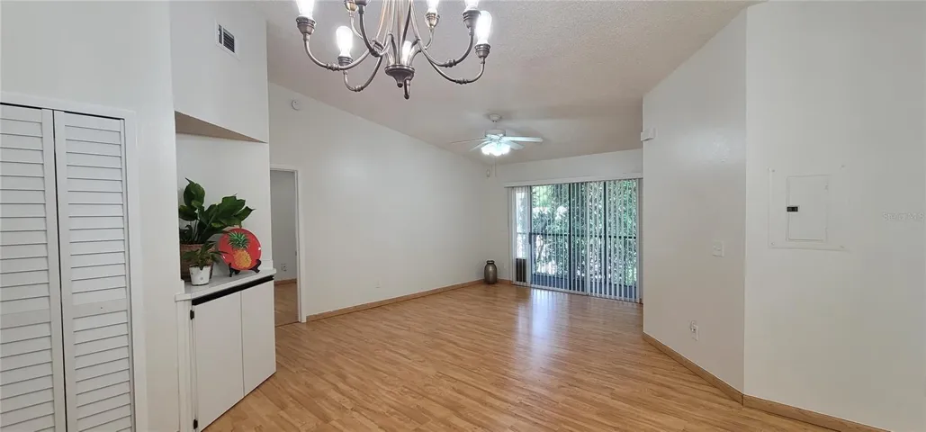 Your big Living Room, with sliding doors to your private screened porch. New paint and EZ care hard floors thru-out!