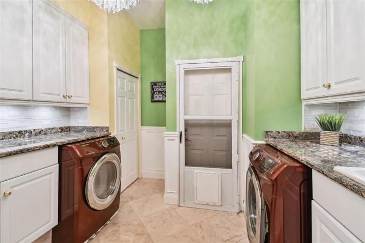 Closet, sink, counters and garage entrance in laundry room